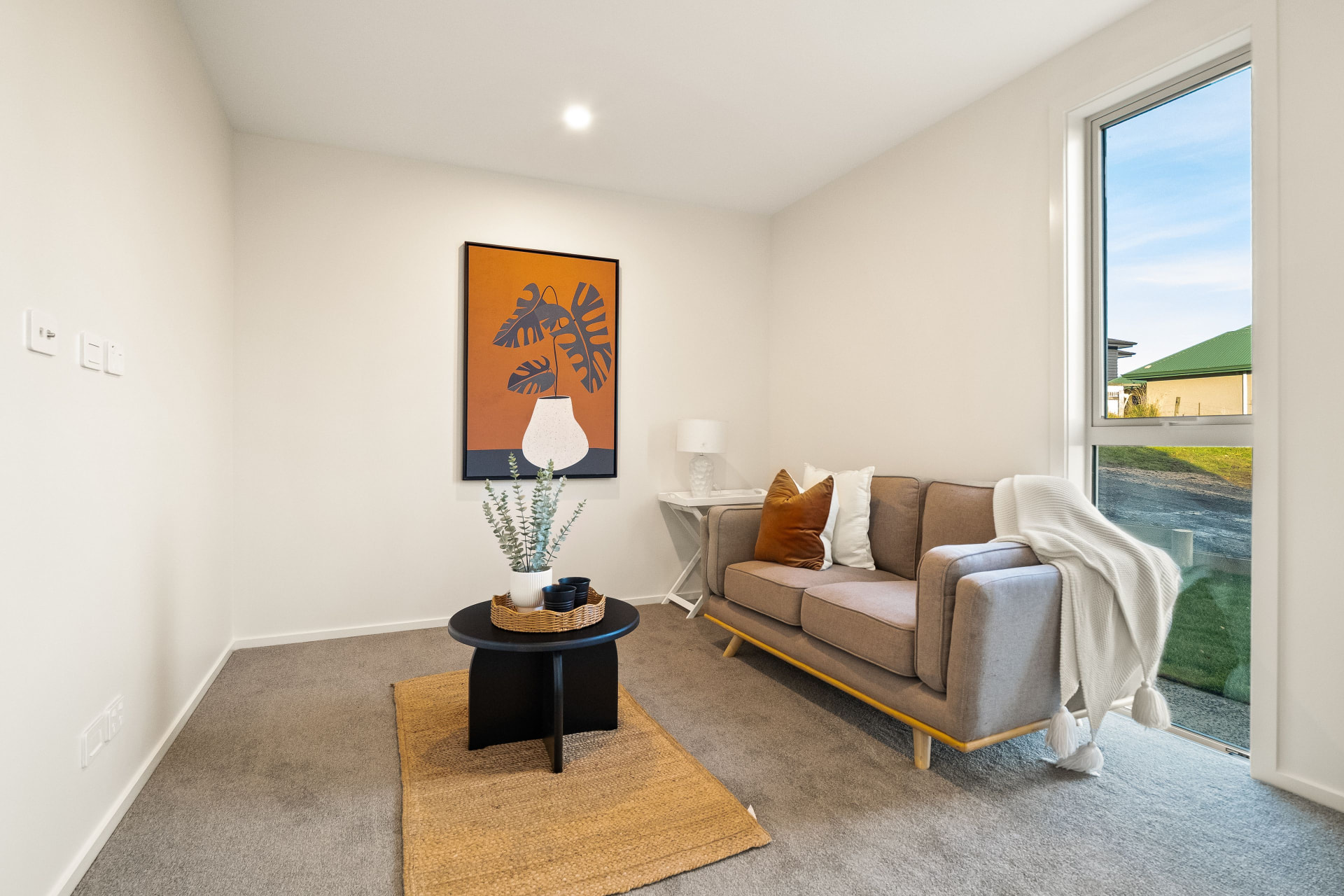 Small lounge with a sofa beside the window